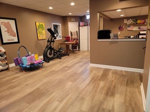 Home gym and play area with workout equipment, colorful toys, and a cozy design.