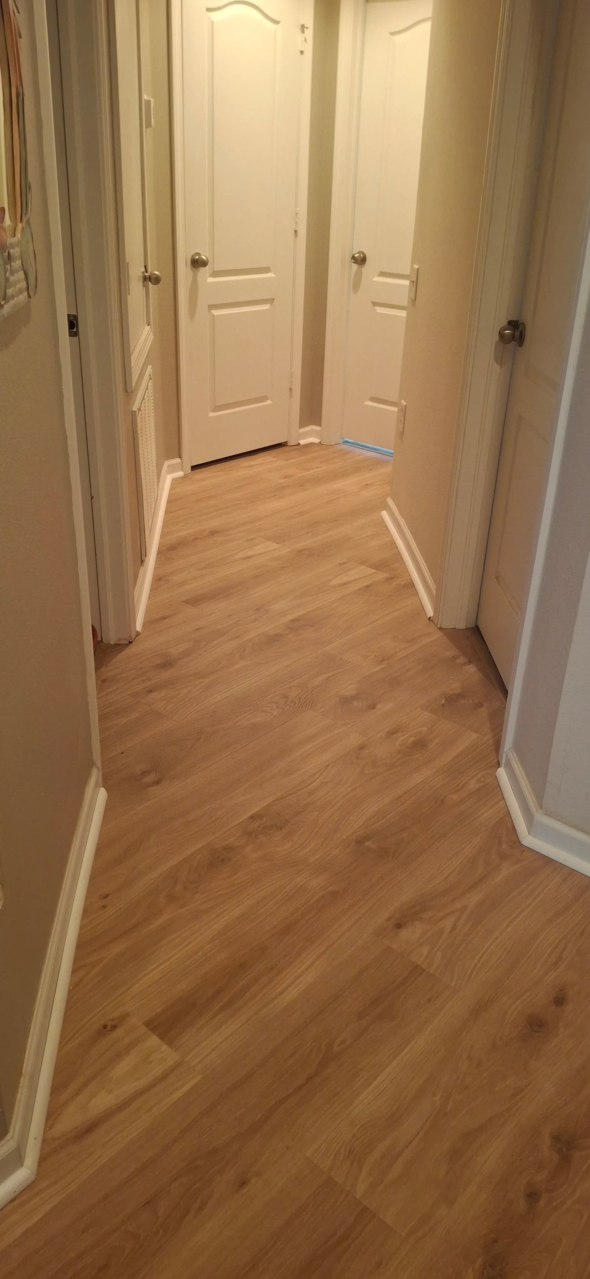 Upper-Level Hallway Gets a Clean Laminate Flooring Upgrade image