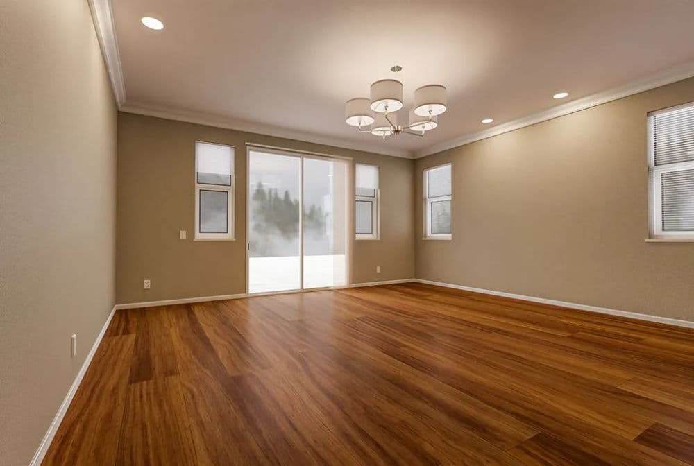 Empty modern living room with hardwood floors, large windows, and stylish chandelier.